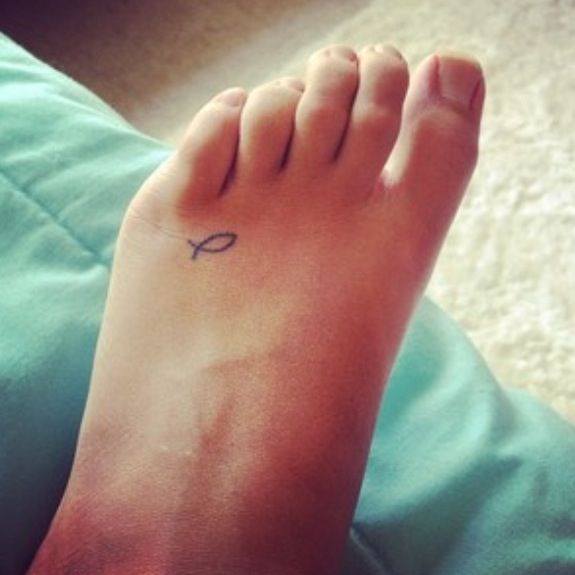 Tiny fish tattoo on the foot