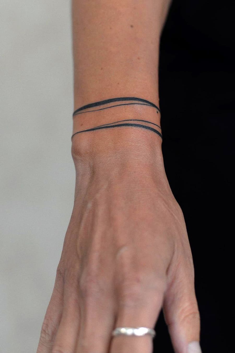 Abstract parallel line armband tattoo