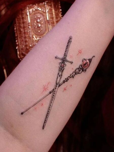 Staff and sword tattoo