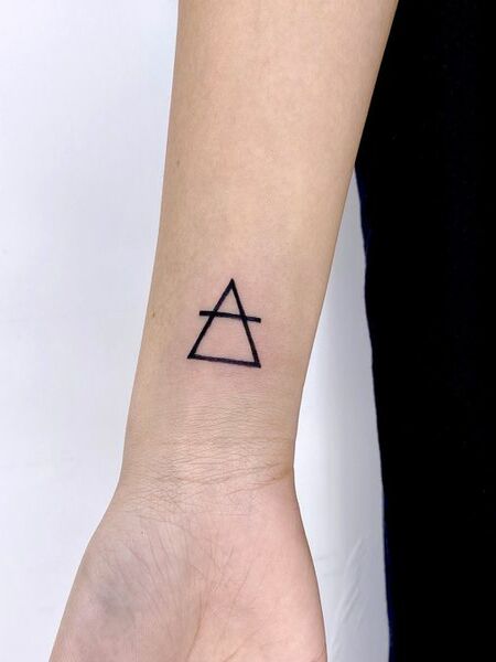 Tiny Symbol Tattoo